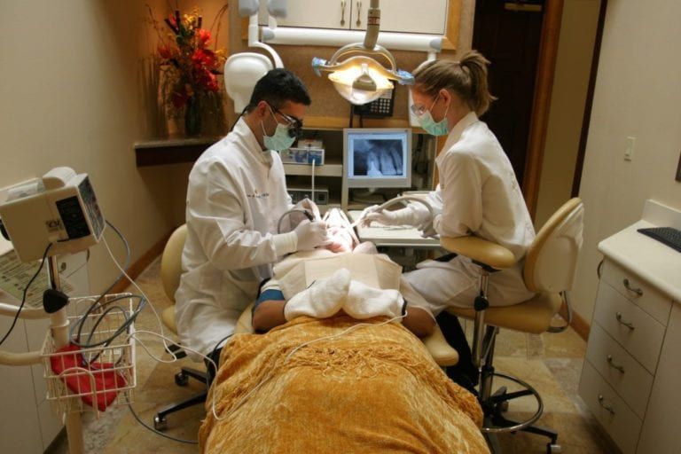male and female dentist performing dental cosmetic surgery