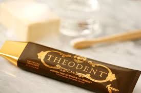 Theodant chocolate toothpaste next to toothbrush on counter