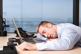 man sleeping at his desk