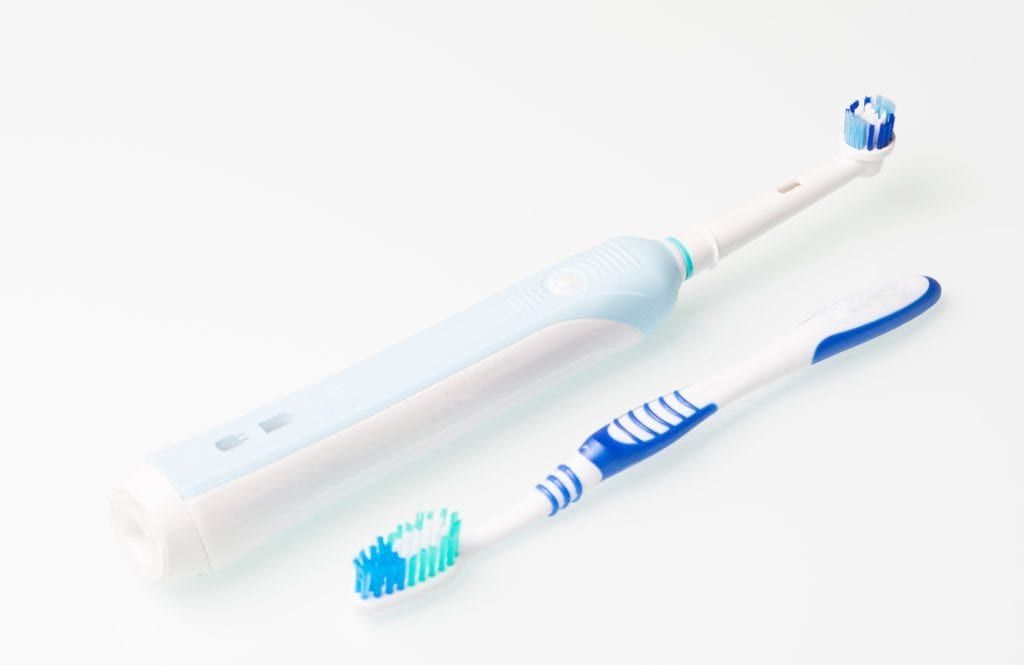 toothbrush and mechanical toothbrush side by side