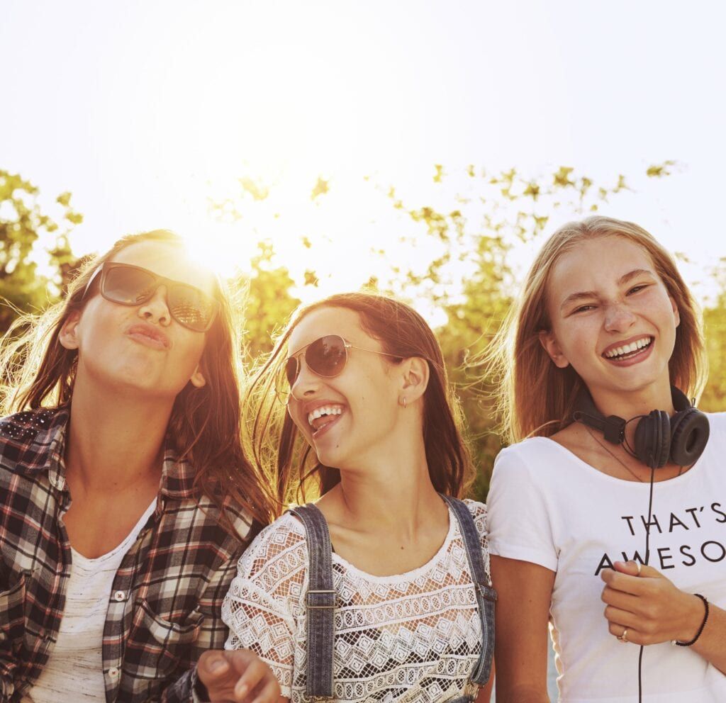 three teenage girls laughing