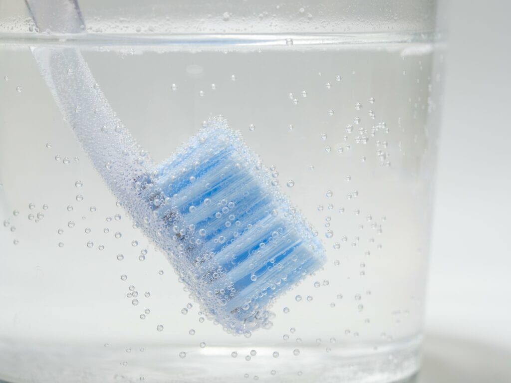 upside down toothbrush in hydrogen peroxide