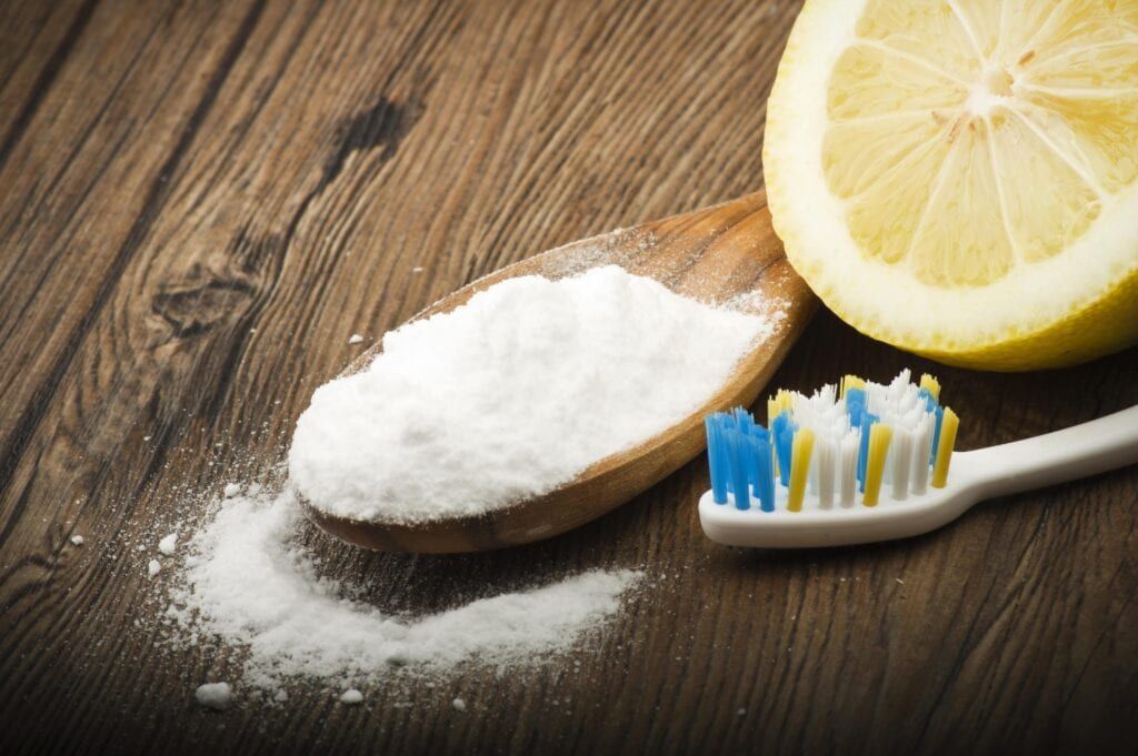 baking soda and lemon by a toothbrush