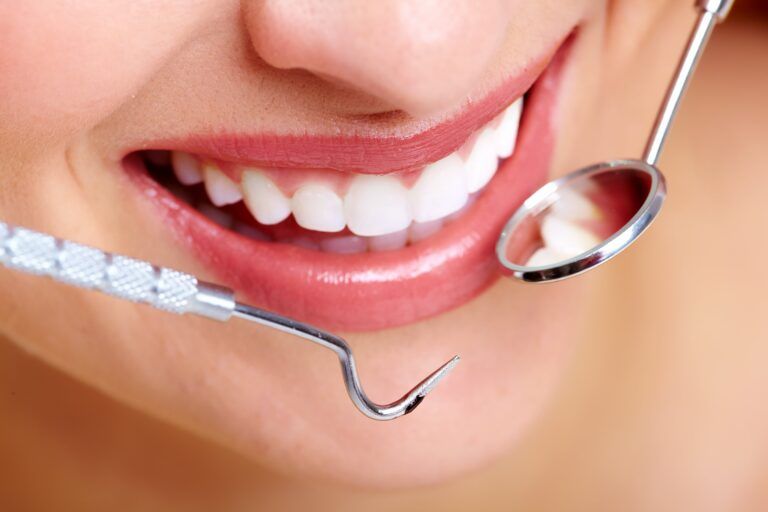 beautiful woman smile and dental tools