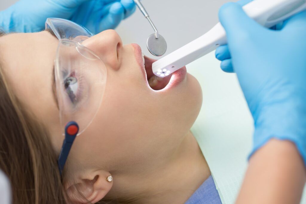 intraoral camera being used in a female patient's mouth